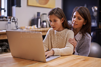 Buy stock photo Mother, child and learning with laptop for support, care or browsing in the kitchen at home. Mom, daughter or kid typing on computer for social media, reading or helping girl on project or homework