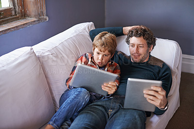 Buy stock photo Father, son and tablet for gaming on couch together, technology and online streaming for bonding at home. Digital world, internet and man with boy child in living room, gamer app and entertainment