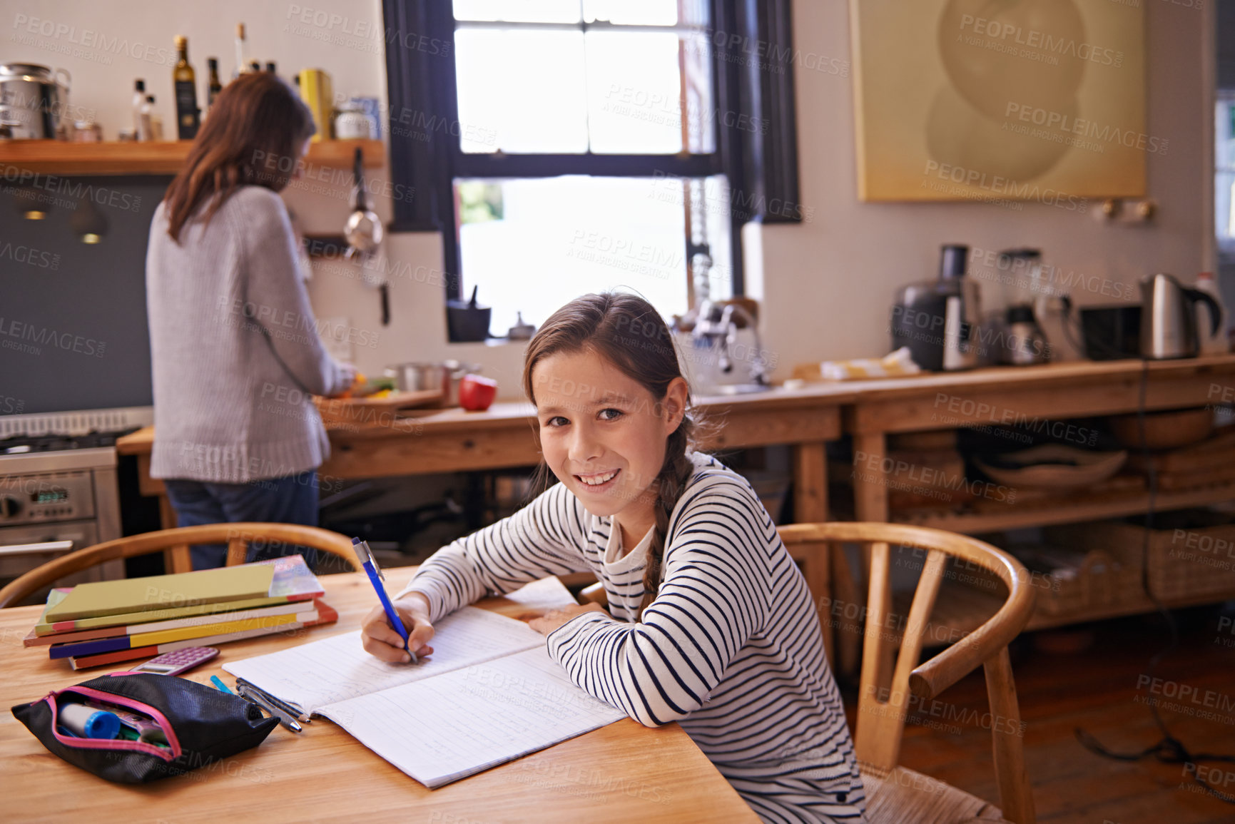 Buy stock photo Girl, child and homework with portrait in kitchen for studying, development and notes for education in house. Kid, notebook and writing with learning, language and smile for assessment in family home