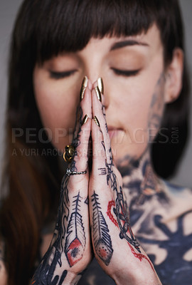 Buy stock photo Woman, tattoo and pray for ink, faith and creative for belief, religion and spiritual for design on closeup. Young person and eyes closed for zen, namaste and nails for varnish and symbol for edgy  
