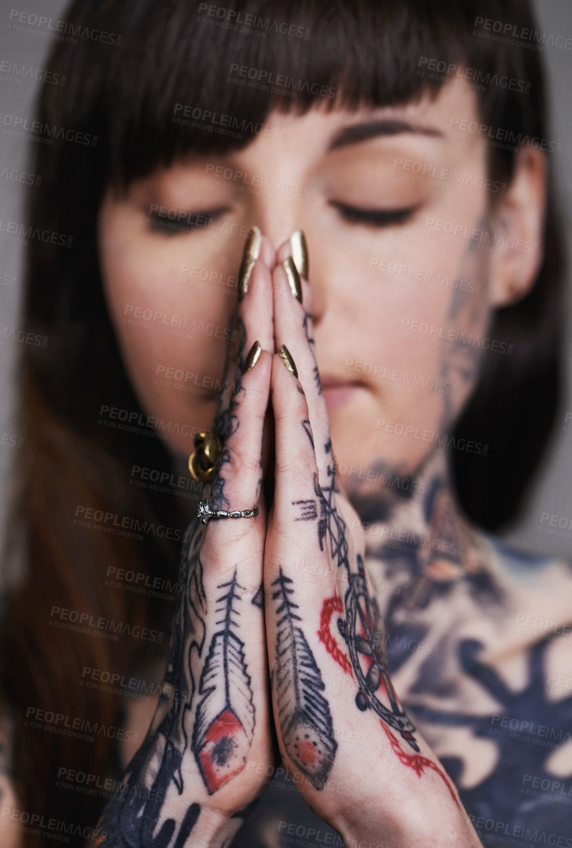 Buy stock photo Woman, tattoo and pray for ink, faith and creative for belief, religion and spiritual for design on closeup. Young person and eyes closed for zen, namaste and nails for varnish and symbol for edgy  