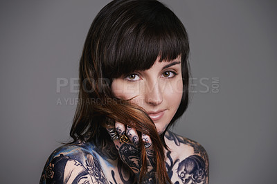 Buy stock photo Happy woman, portrait and beauty with tattoo art for style or facial treatment on a gray studio background. Face of female person or young model with smile for body artwork, design or creativity