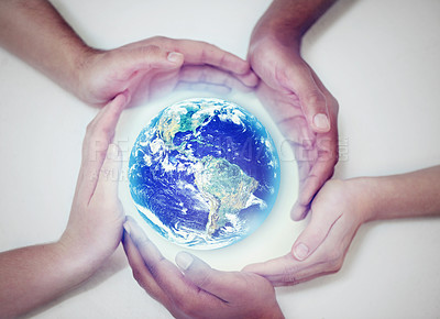 Buy stock photo A cropped view of human hands encircling the planet to protect it