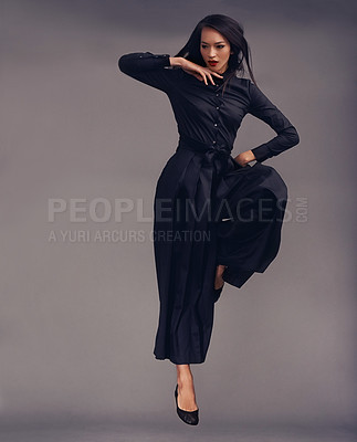 Buy stock photo Exercise, woman and martial arts training, jump and warrior isolated on studio background. Lady, female and ninja with traditional outfit, focus and practice for self defense and character in air