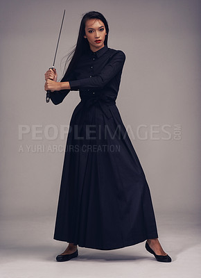 Buy stock photo Samurai, sword and portrait of a ninja in a studio with a martial arts or assassin fighter skill. Fantasy, cosplay and female model in a warrior costume with a machete posing by a gray background.
