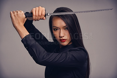 Buy stock photo Portrait, sword and ninja with a model woman in studio on a gray background for martial arts or combat. Training, fantasy and weapon with an asian samurai ready to defend using self discipline