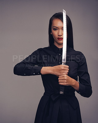 Buy stock photo Portrait, samurai and warrior with an asian woman in studio on a gray background for martial arts or combat. Training, fantasy and weapon with a model ninja ready to defend using self discipline