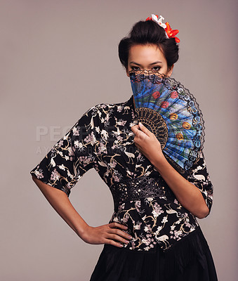 Buy stock photo Asian woman, fashion and hand fan with confidence in  studio on brown background in traditional style and elegant. Portrait, Japanese and female person with designer clothes or outfit for culture 
