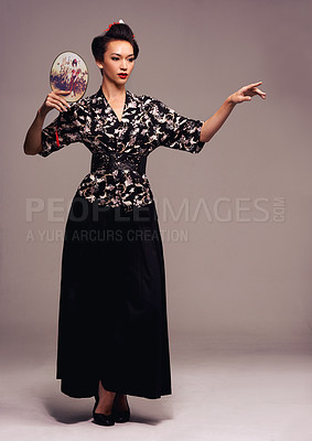 Buy stock photo Fashion, dance and Japanese woman with geisha fan and Asian clothing with traditional outfit in studio. Culture, creative and heritage clothes with female person from Japan with brown background