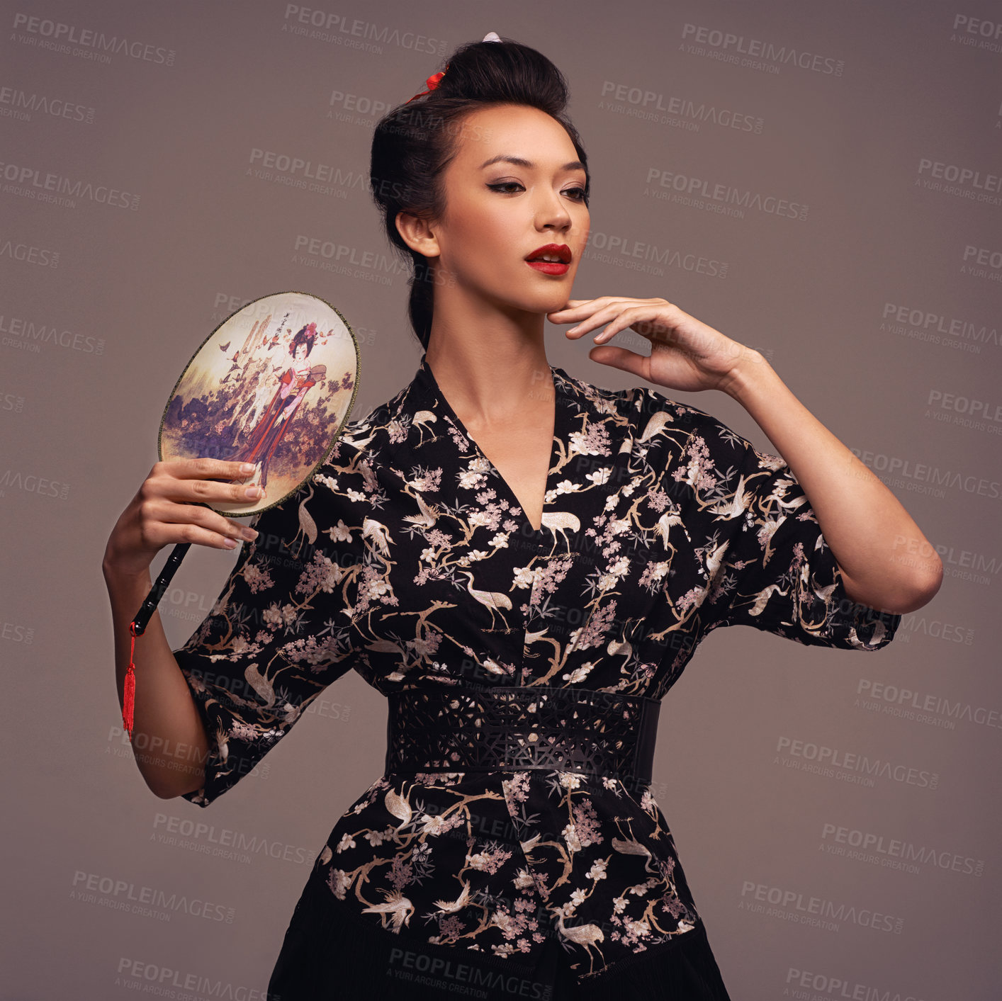 Buy stock photo Asian woman, clothes and traditional fan in studio on brown background in confidence, style and elegant. Japanese, female person and designer outfit or fashion for creativity, culture and heritage.