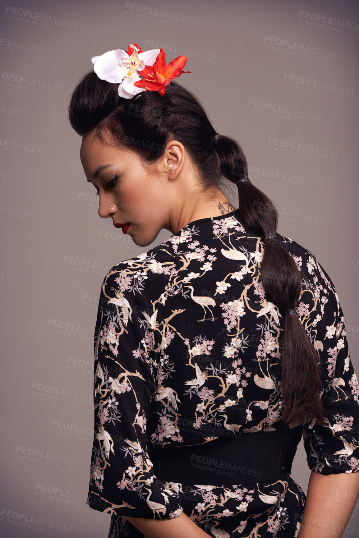 Buy stock photo Studio shot of an attractive young woman dressed in traditional asian clothing