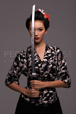 Buy stock photo Asian woman, fashion and sword in studio on confidence with grey background, traditional style and elegant. Portrait, Japanese and female person with designer, fashion and outfit for heritage 