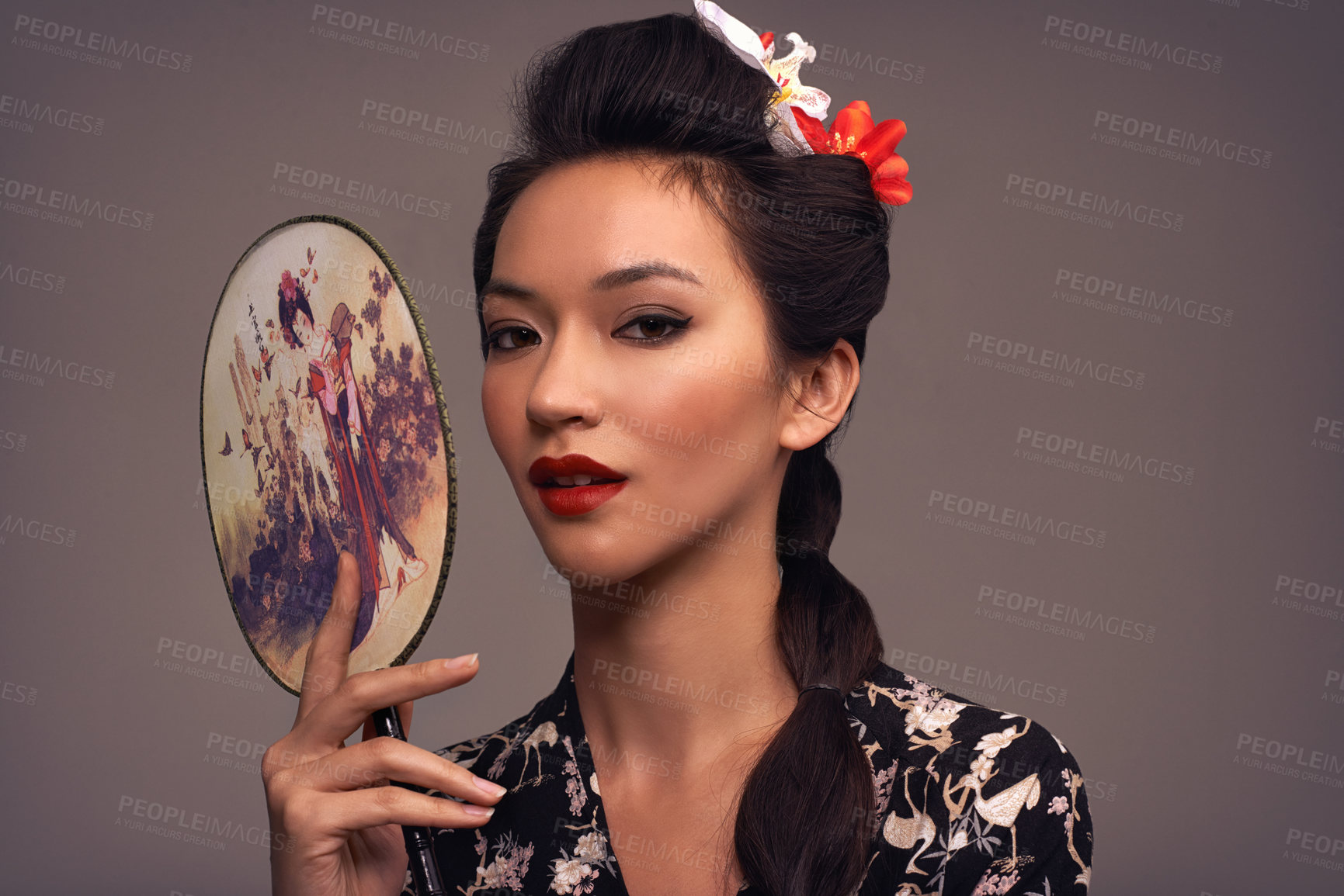 Buy stock photo Face, Asian woman and beauty with hand mirror in studio on brown background in traditional style and elegant. Portrait, Japanese and female person with fashion, outfit and makeup for heritage
