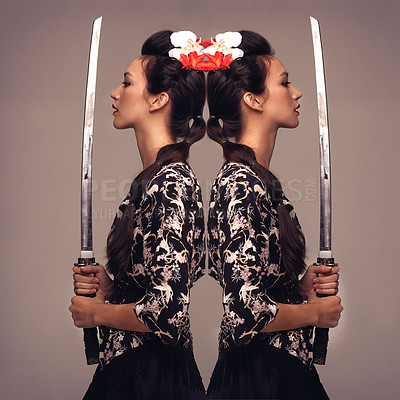 Buy stock photo Mirrored studio shot of an attractive young woman holding a samurai sword