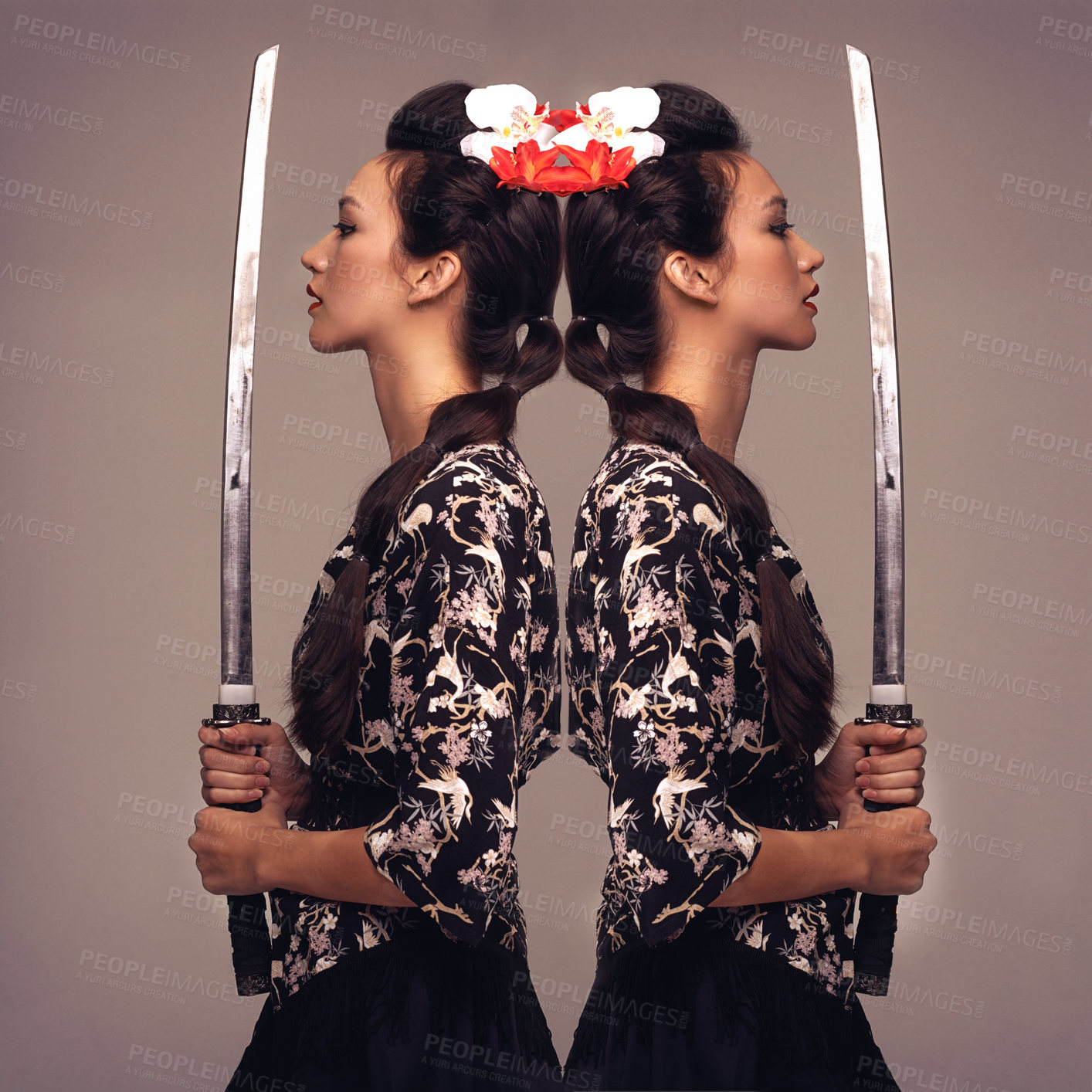 Buy stock photo Mirrored studio shot of an attractive young woman holding a samurai sword