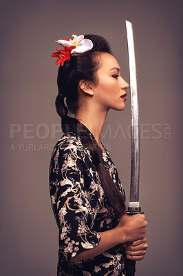 Buy stock photo Japanese woman, fashion and sword with confidence in studio on brown background in traditional style and elegant. Asian, culture and female person with designer clothes or outfit for heritage 
