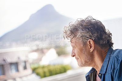 Buy stock photo A mature man looking out of a window thoughtfully