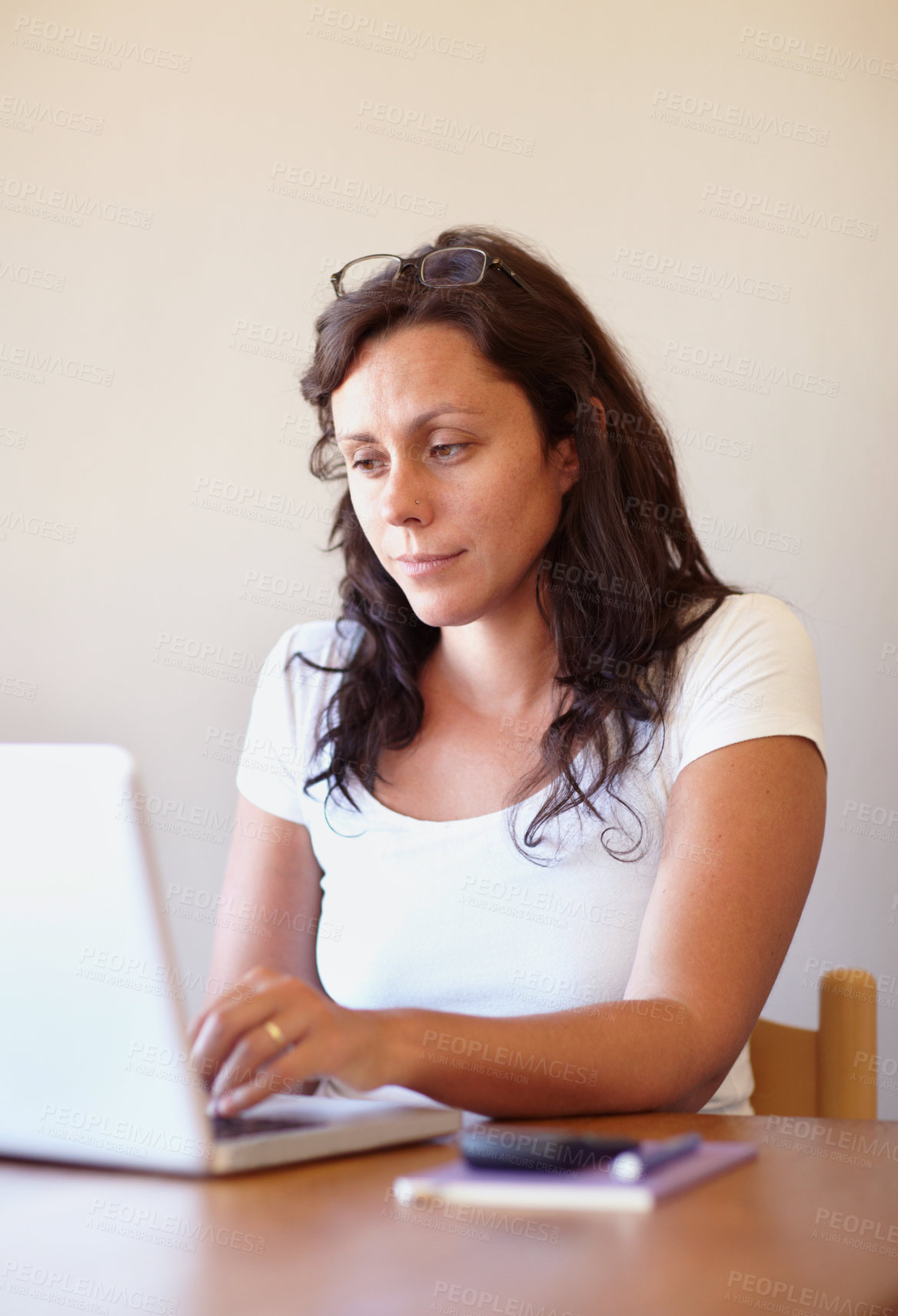 Buy stock photo Cropped view of a casually dressed entrepreneur working on her laptop