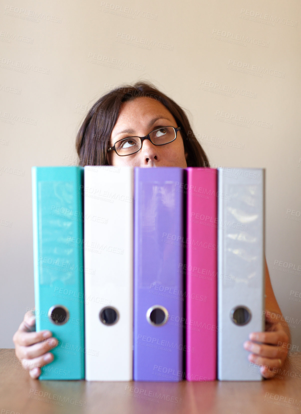 Buy stock photo A young woman holding several files