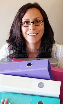 Buy stock photo A young woman holding several files