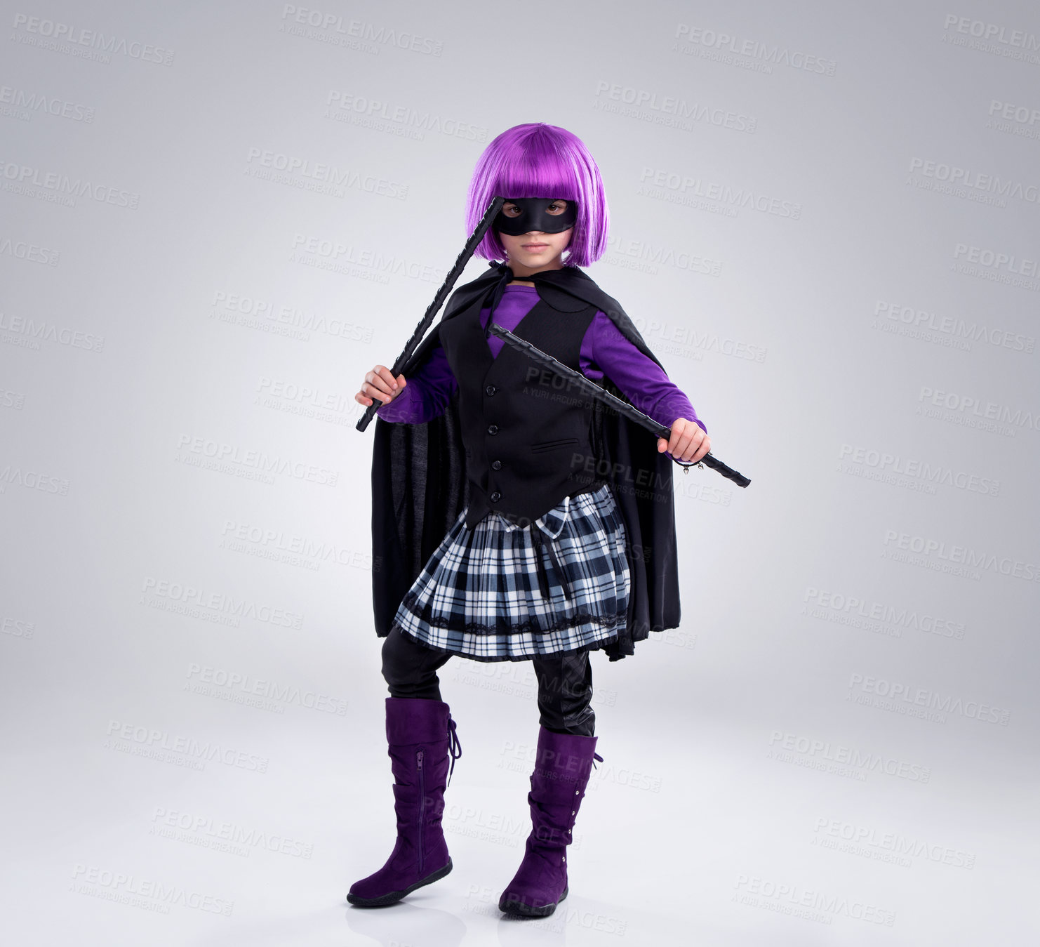 Buy stock photo Girl child, costume and villain in studio portrait with weapons, fantasy and creative comic aesthetic. Kid, superhero game, mask and creative for martial arts, vigilante or cosplay by gray background