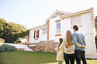 Buy stock photo A family standing outdoors admiring their new home