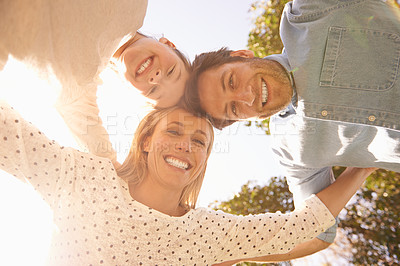 Buy stock photo Face portrait, sky and happy family hug, love and solidarity circle of child, mom and dad bonding in nature park. Care, fresh air and below view of people smile for natural sunshine, freedom or peace