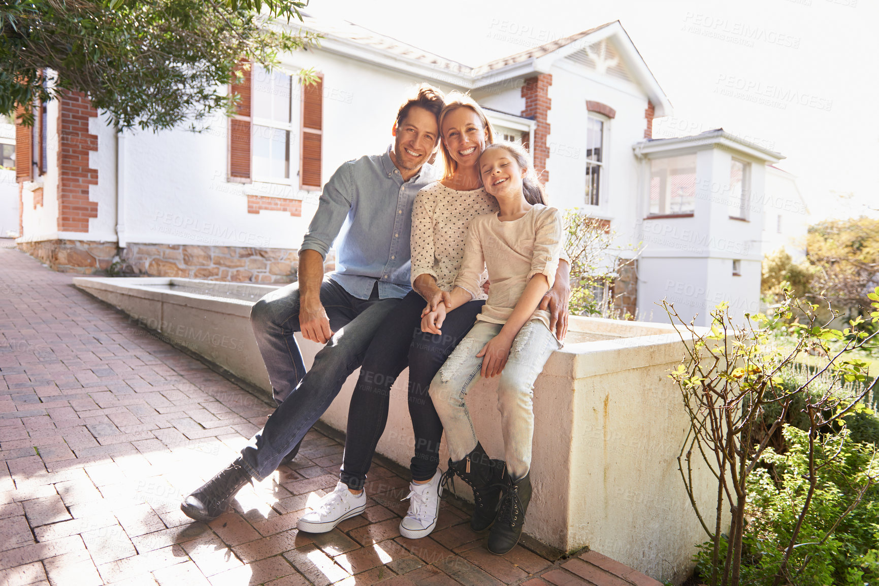 Buy stock photo A portrait of a happy family sitting outside of their home