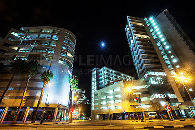 Buy stock photo Night, cityscape sky and urban buildings at dark with lights in Cape Town outdoor with architecture. Street, lighting and city infrastructure with fountain and skyline at evening outdoors with road