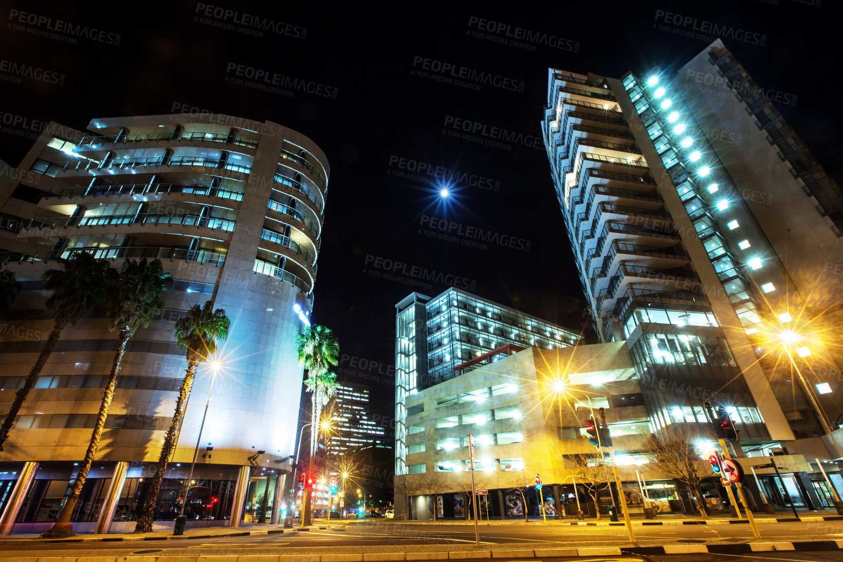 Buy stock photo Night, cityscape sky and urban buildings at dark with lights in Cape Town outdoor with architecture. Street, lighting and city infrastructure with fountain and skyline at evening outdoors with road