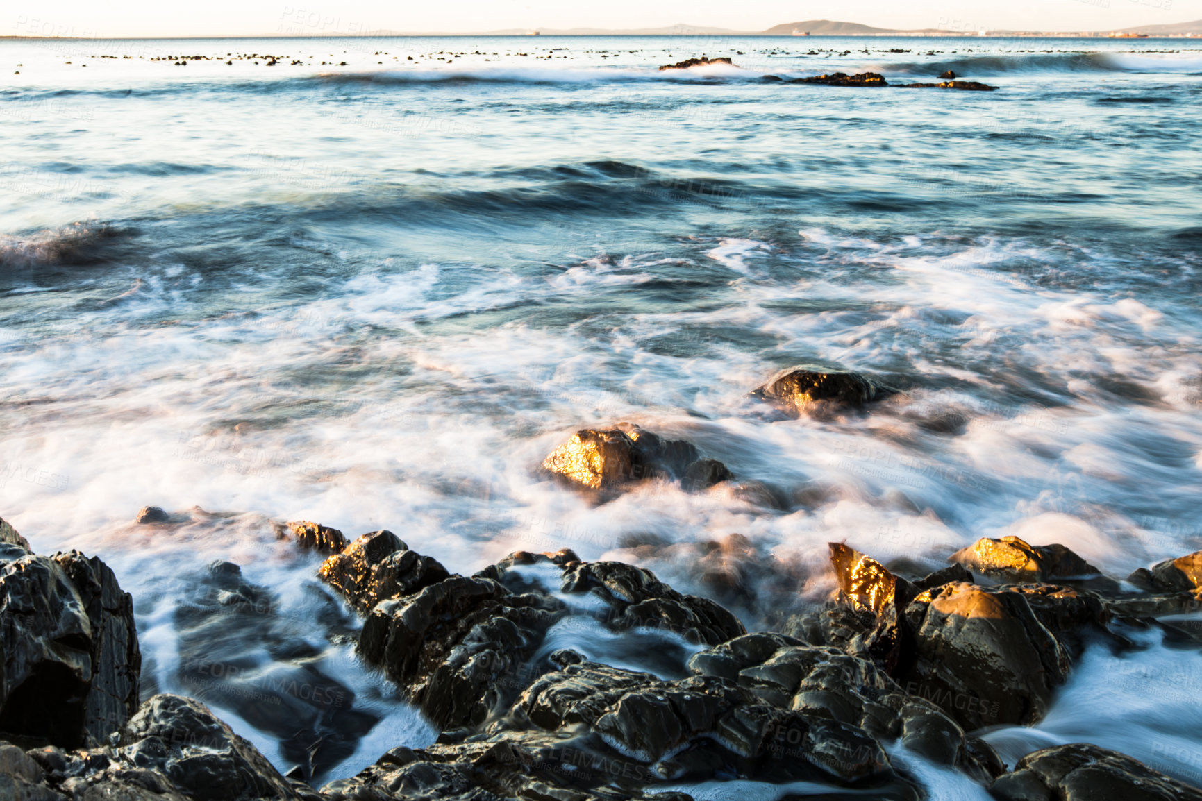 Buy stock photo Rock, ocean and water with waves at beach for environment, landscape and blue sky. Calm, summer and natural with morning seascape on horizon for tropical coastline, marine and nature long exposure