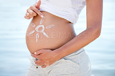Buy stock photo Pregnant, sunscreen and a woman on the beach during summer for sun protection or care on holiday or vacation. Mother, skincare and pregnancy with female tourist outdoor to apply sunblock to her belly