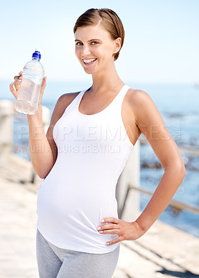 Buy stock photo Pregnant woman, water bottle and outdoor at beach with prenatal health, fitness with h2o and ocean. Nutrition, pregnancy and thirsty mom, hydration and exercise in portrait with drink for wellness 