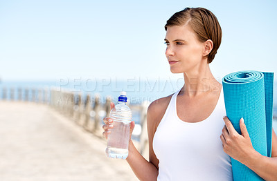 Buy stock photo Shot of a beautiful pregnant woman getting ready for a workout at the seaside 
