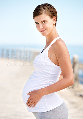 Buy stock photo Healthy, portrait and pregnant woman with fitness outdoor at beach for walk or workout in morning. Prenatal, training and care for body in pregnancy with happiness and wellness in summer at the ocean