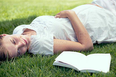 Buy stock photo Pregnant, spring and woman reading book in nature outdoor for relax, wellness and peace on field. Pregnancy, literature and happy mother lying down for happiness, leisure and stomach in garden