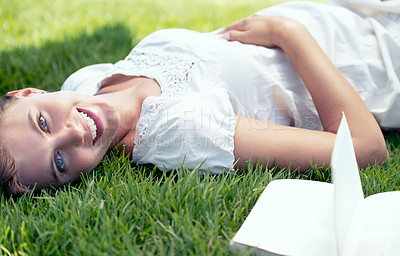 Buy stock photo Pregnant, spring and portrait of woman reading book in nature outdoor for relax, wellness and peace on field. Pregnancy, literature and mother lying down for happiness, leisure and stomach in garden