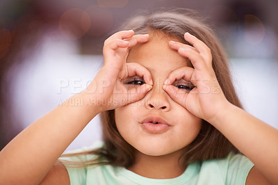 Buy stock photo Shot of a playful little girl with pulling a funny face