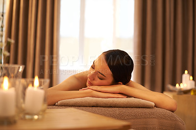 Buy stock photo A beautiful young woman relaxing on a massage table before her massage