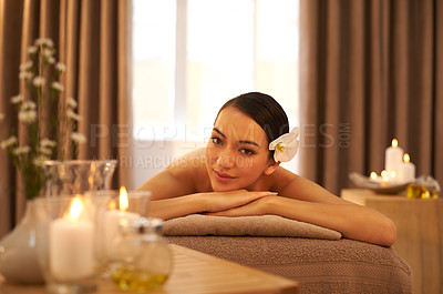 Buy stock photo Spa, bed and portrait of woman with candle for aromatherapy, stress relief or holistic body massage. Asian person, zen face and smile at luxury hotel for hospitality, self care and natural wellness