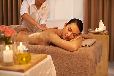 Buy stock photo Back massage, therapist and woman relax in spa for skincare, wellness or health at table for luxury. Body, pamper or hands of masseuse at salon for beauty, peace or calm with candles for aromatherapy