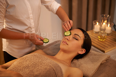 Buy stock photo Face, massage therapist and woman with cucumber in spa for peace, relax or wellness. Facial, salon or hands apply vegetable on eyes for natural beauty, skincare or healthy organic treatment with mask