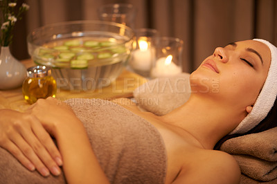 Buy stock photo A young woman lying in a day spa