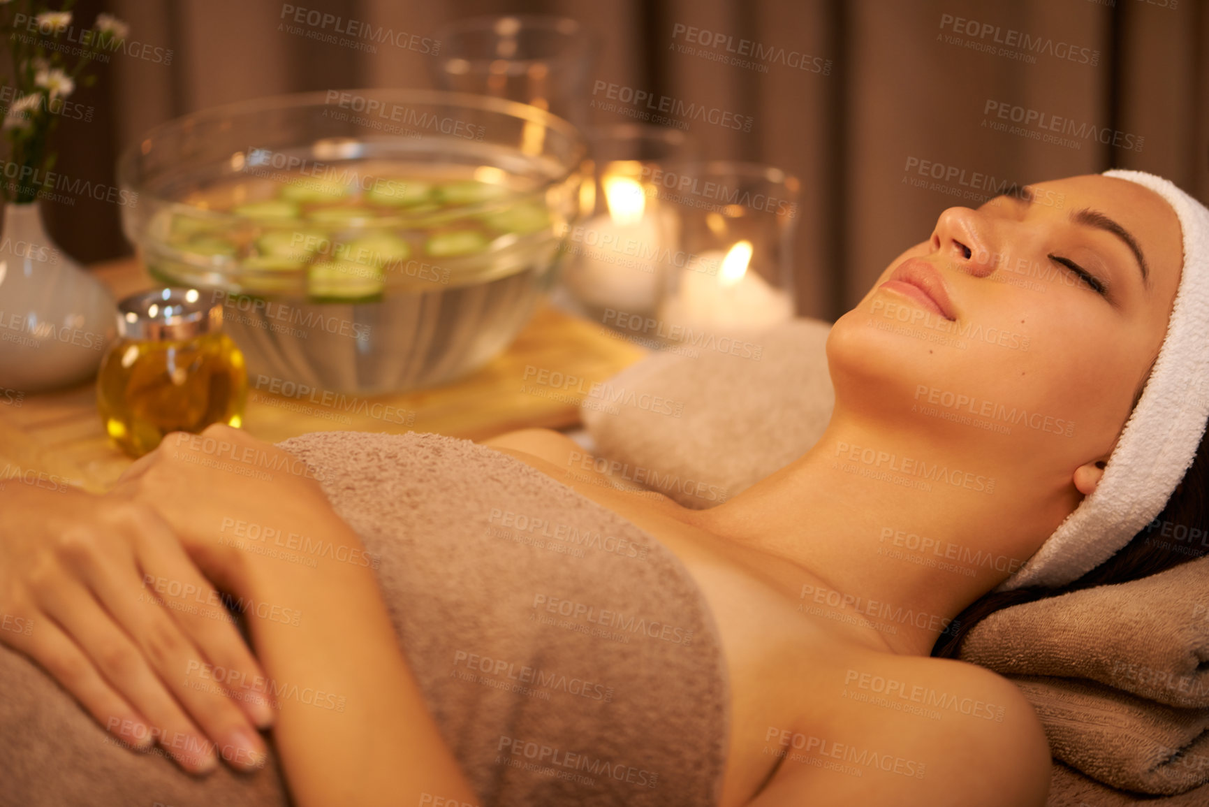 Buy stock photo A young woman lying in a day spa