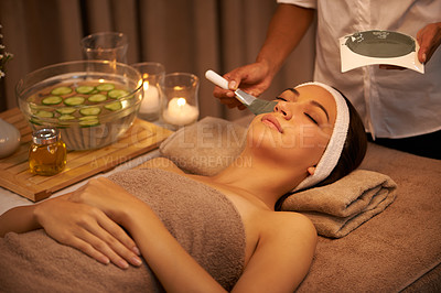 Buy stock photo A young woman lying in a day spa with a face mask being applied