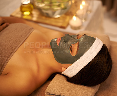 Buy stock photo A young woman lying in a day spa with a face mask on