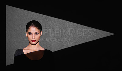 Buy stock photo Portrait, abstract and woman with light of triangle, shape and isolated on gray background. Female person, lady and spotlight on face for cosmetics, beauty and makeup by mockup on studio backdrop
