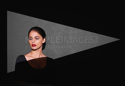 Buy stock photo Beauty, art and woman with light of triangle, shape or serious isolated on gray background. Female person, lady or spotlight on face for cosmetics, skincare or makeup by mockup on studio backdrop