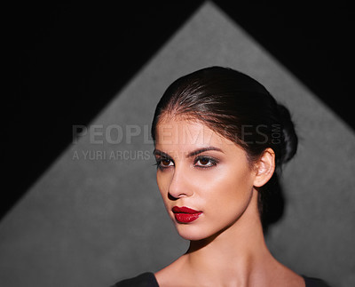 Buy stock photo A beautiful fashion model highlighted by a shaped portion of light