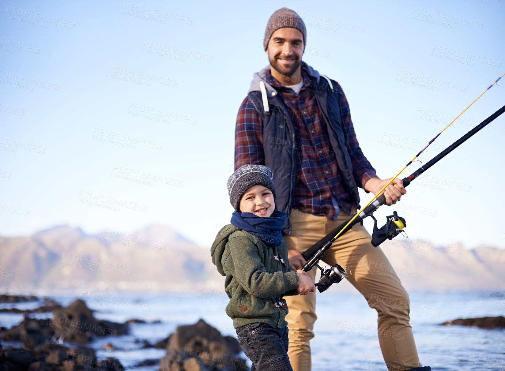 Buy stock photo Father, kid and happy for fishing at sea in winter as hobby with bonding for child development, growth and life skills in Australia. Man, boy and stand at coast for family tradition, memory and care